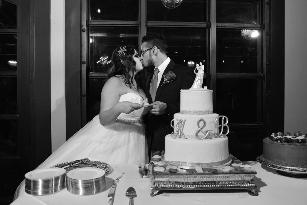 wedding couple kissing and eating cake